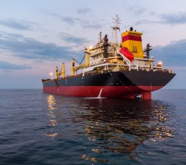Large general cargo ship tanker bulk carrier, aerial view at night.