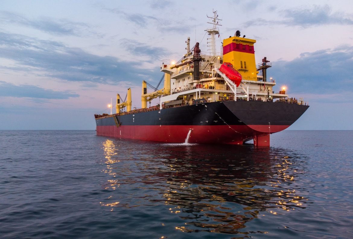 Large general cargo ship tanker bulk carrier, aerial view at night.